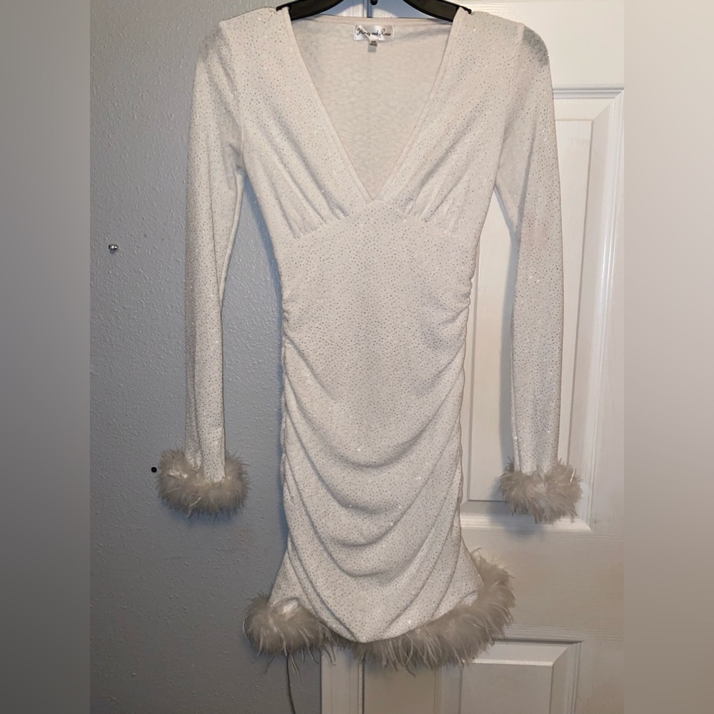 White formal dress. Has feathers on bottom and on the wrists.